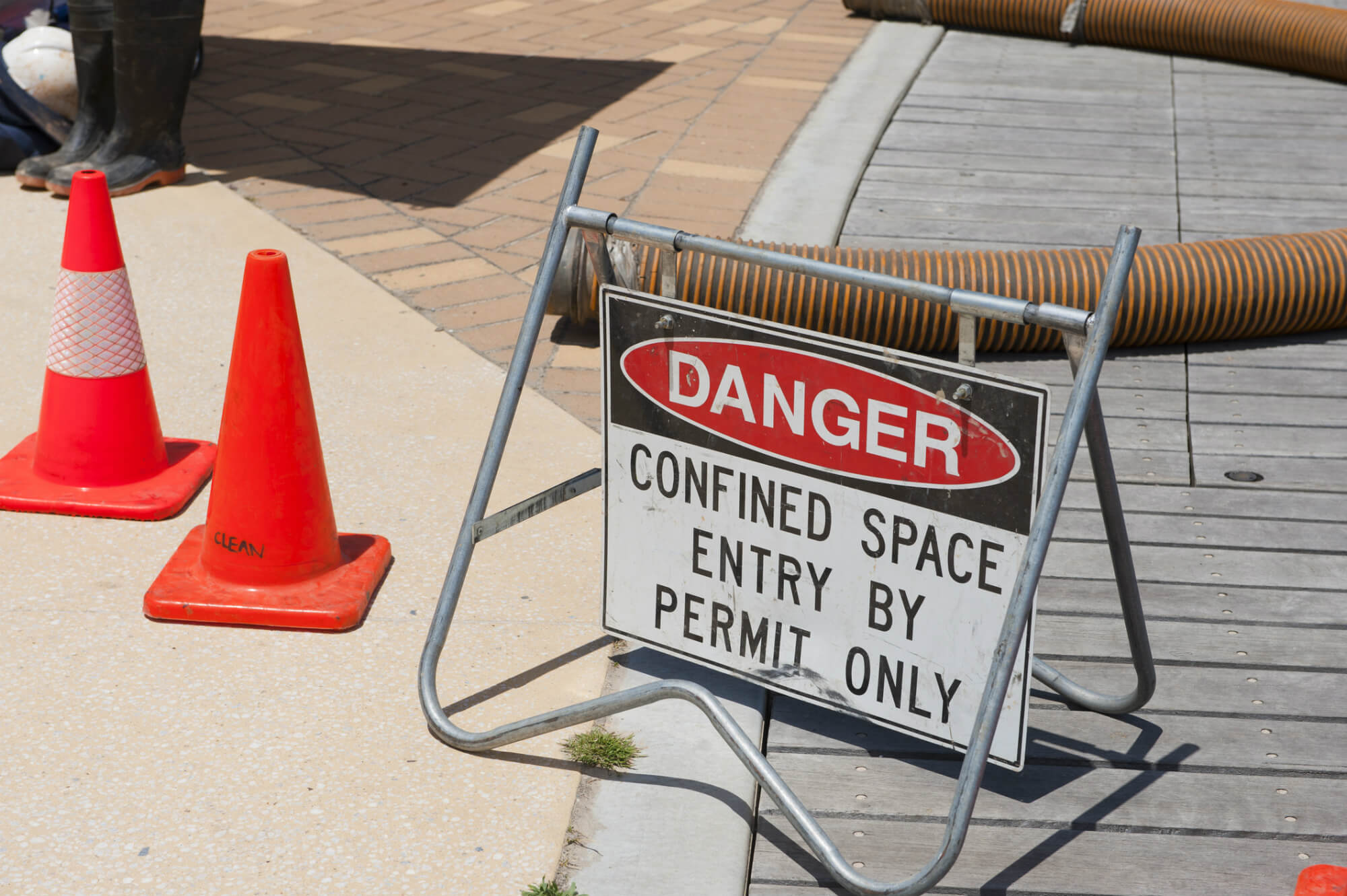 What risks need to be considered when rescuing someone from a confined space?