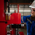 Engineer inspecting a hydraulic press.
